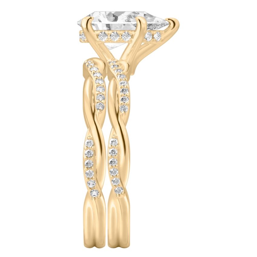 Side view of pear shape diamond twist hidden halo engagement ring set yellow gold