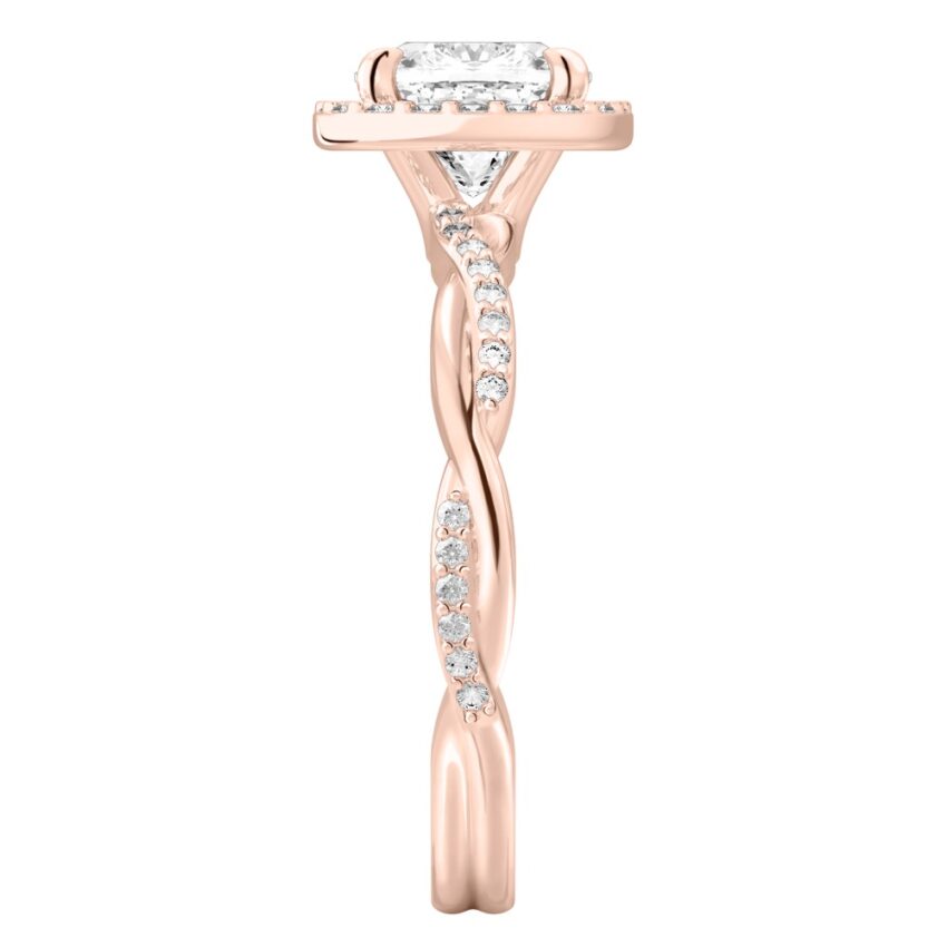 Side view of cushion cut diamond twist halo engagement ring in rose gold