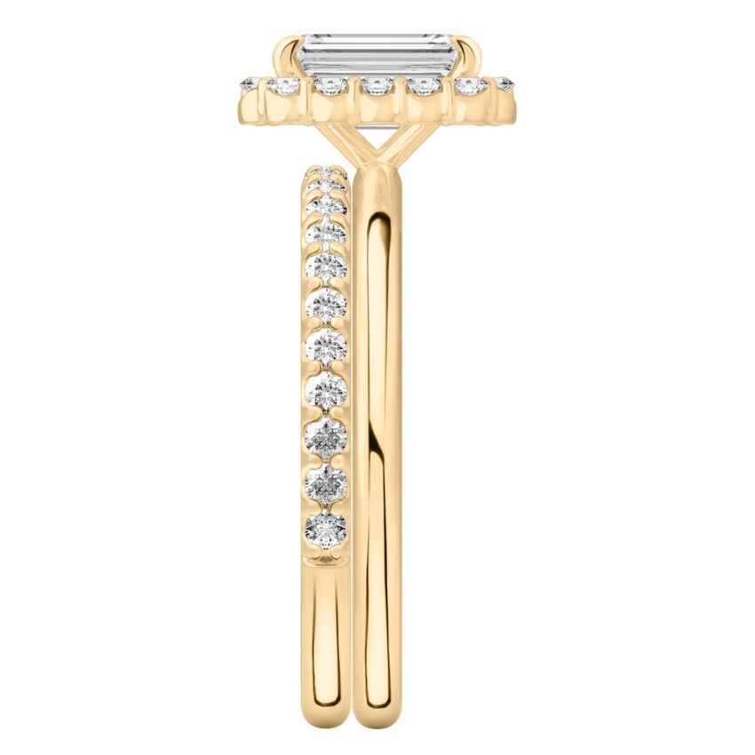 Side view of emerald cut diamond floral halo engagement ring set yellow gold