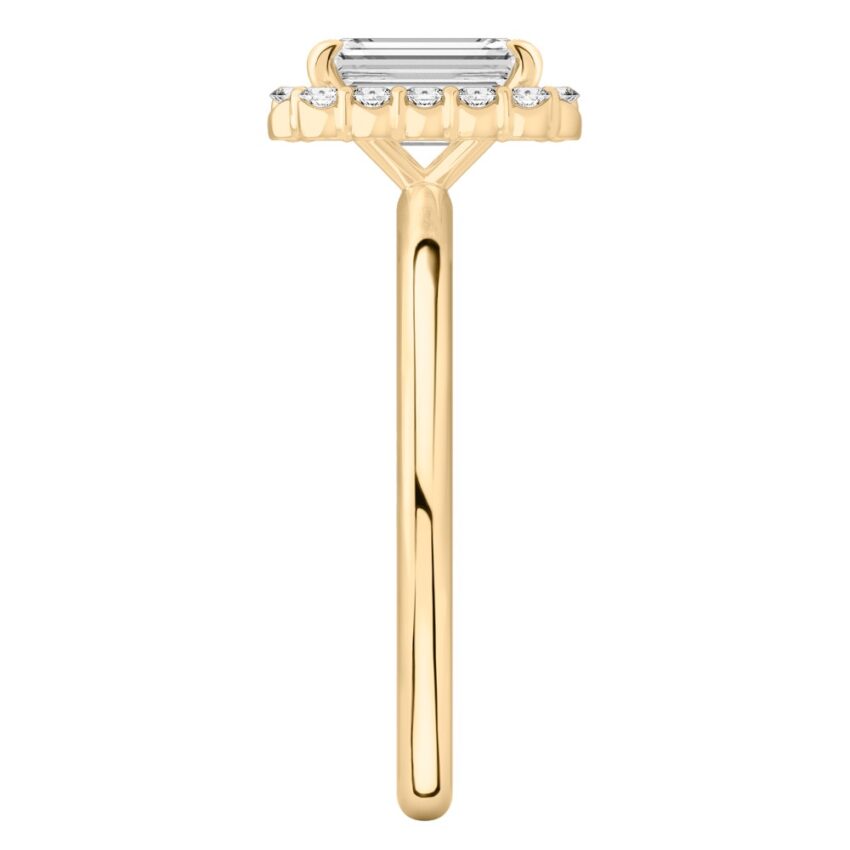 Side view of emerald cut diamond floral halo engagement ring in yellow gold