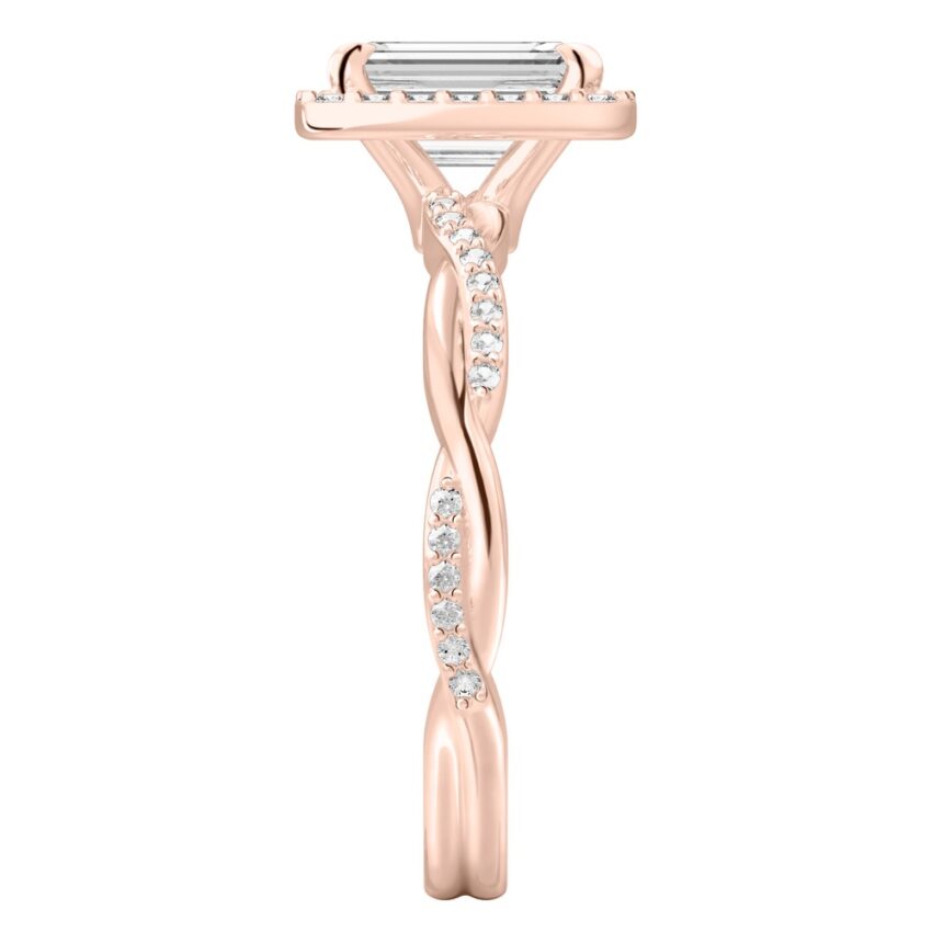 Side view of emerald cut diamond twist halo engagement ring in rose gold