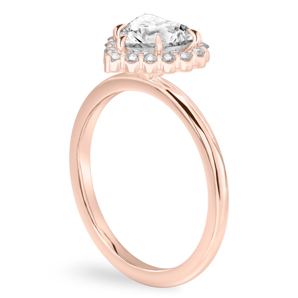 Angle view of heart shape diamond floral halo engagement ring in rose gold