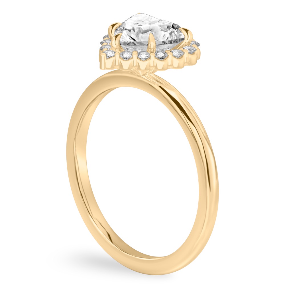 Angle view of heart shape diamond floral halo engagement ring in yellow gold