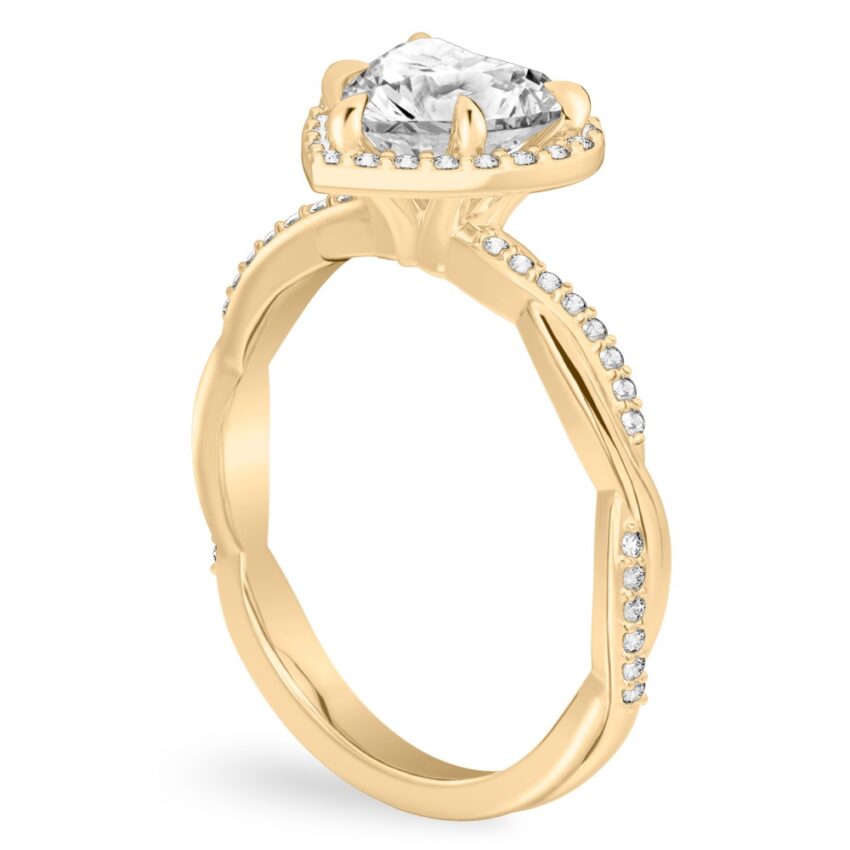 Angle view of heart shape diamond twist halo engagement ring in yellow gold