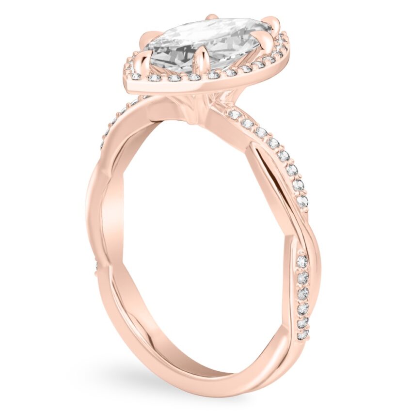 Angle view of marquise cut diamond twist halo engagement ring in rose gold