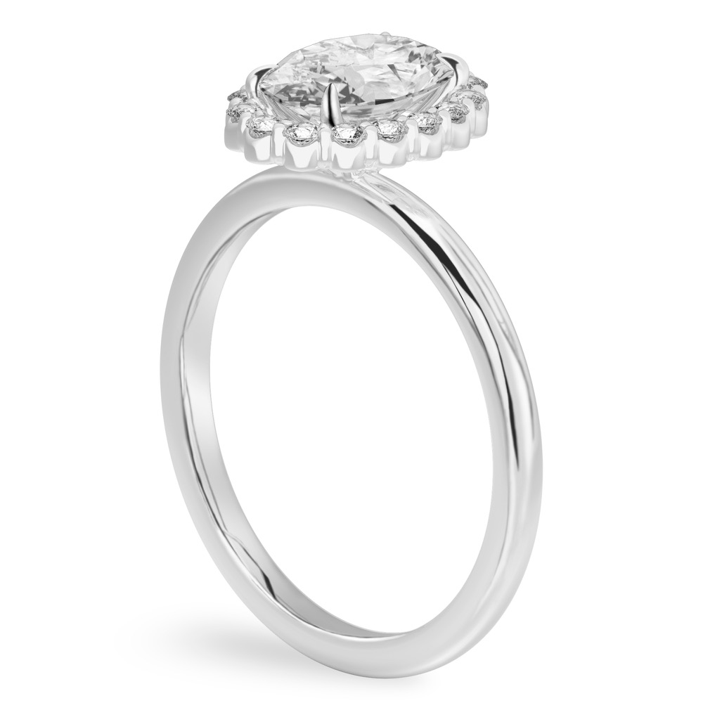 Angle view of oval cut diamond floral halo engagement ring in platinum