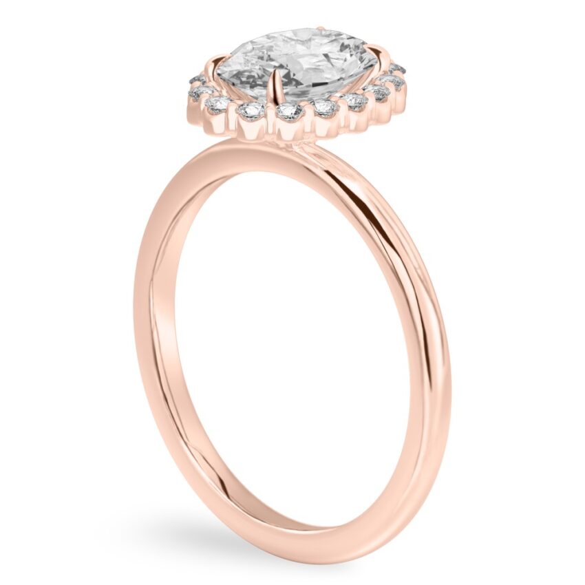 Angle view of oval cut diamond floral halo engagement ring in rose gold