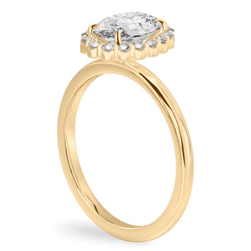Angle view of oval cut diamond floral halo engagement ring in yellow gold