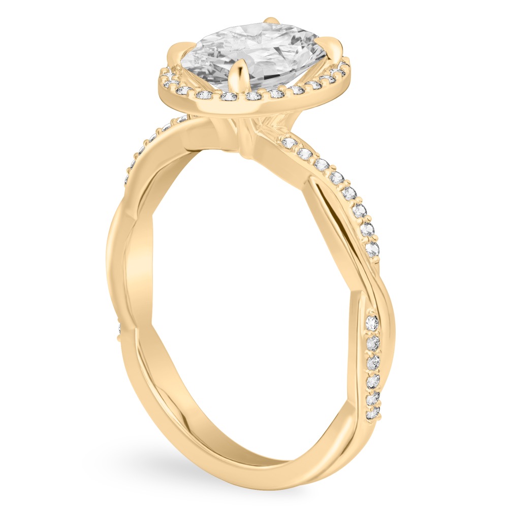 Angle view of oval cut diamond twist halo engagement ring in yellow gold
