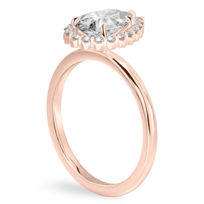 Angle view of pear shape diamond floral halo engagement ring in rose gold