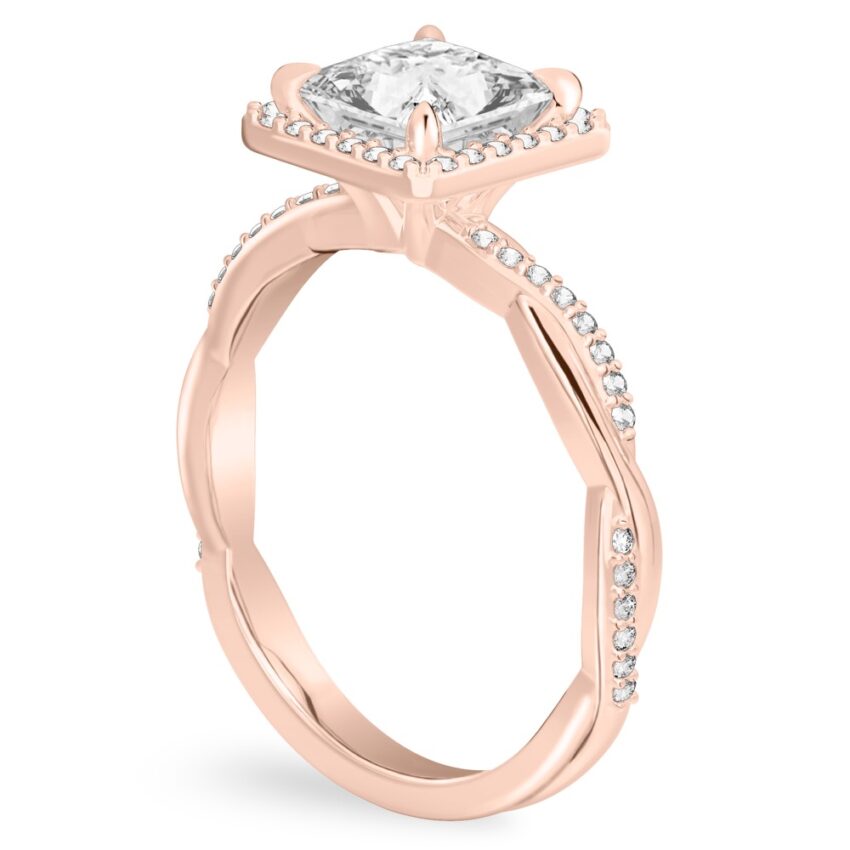 Angle view of princess cut diamond twist halo engagement ring in rose gold