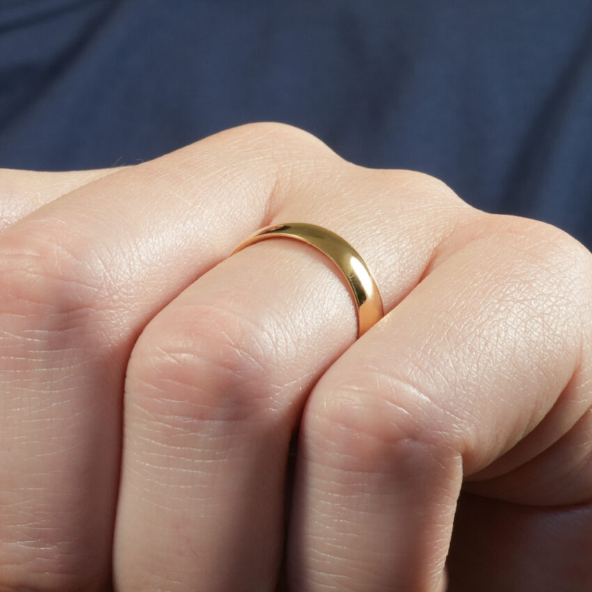 Angle view of men's comfort-fit wedding band in lifestyle