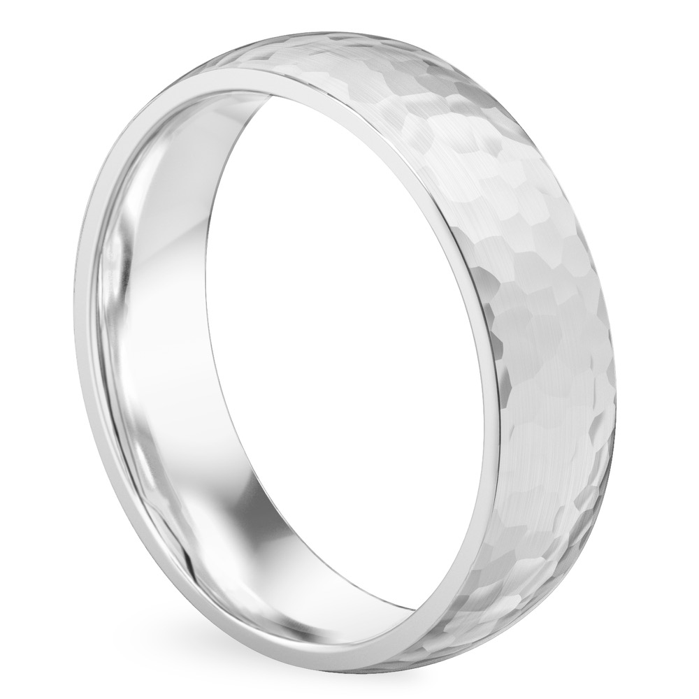 Angle view of domed hammered wedding band in platinum