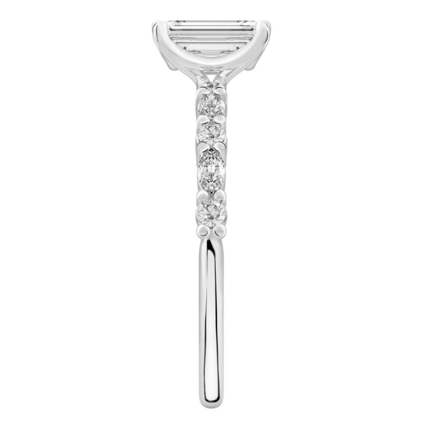 Side view of emerald cut diamond marquise and round diamond ring palladium