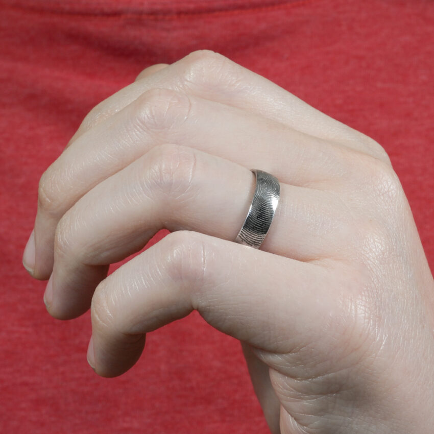 Angle view of fingerprint wedding band in lifestyle
