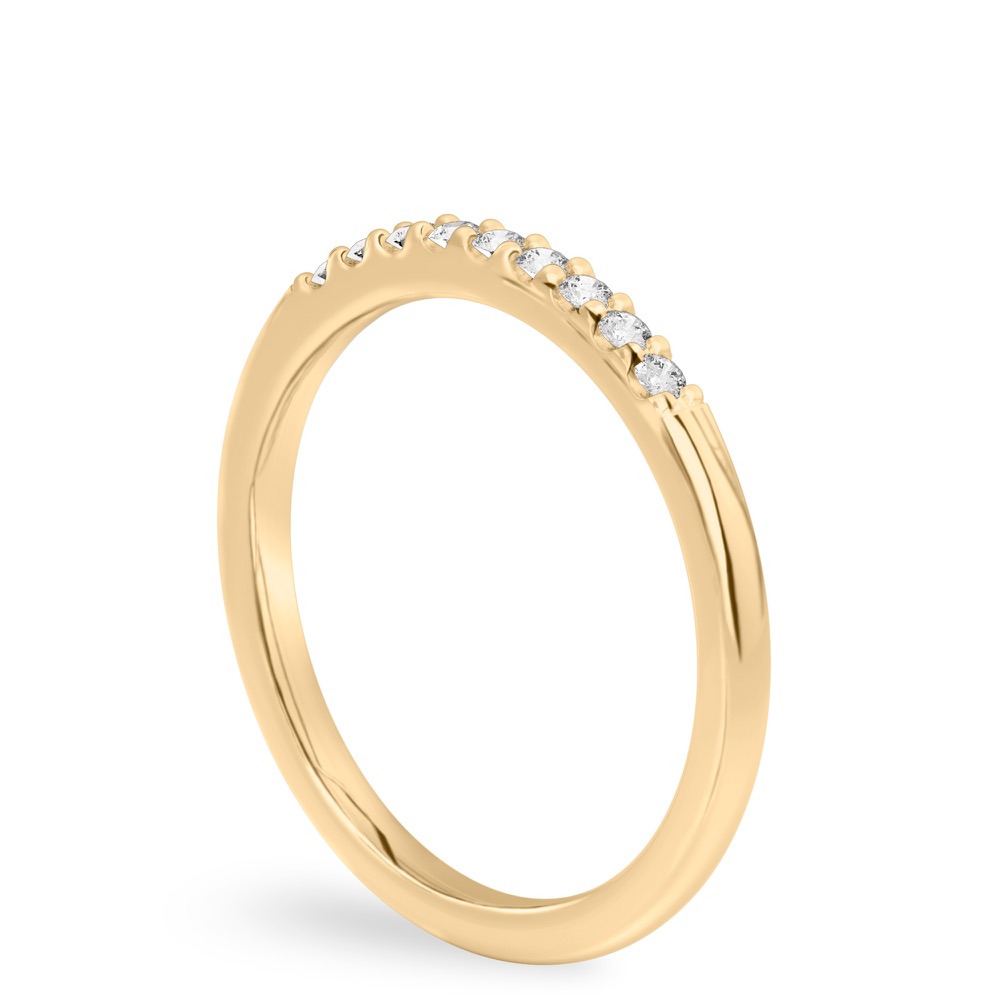Angle view of minimalist pave wedding band in yellow gold