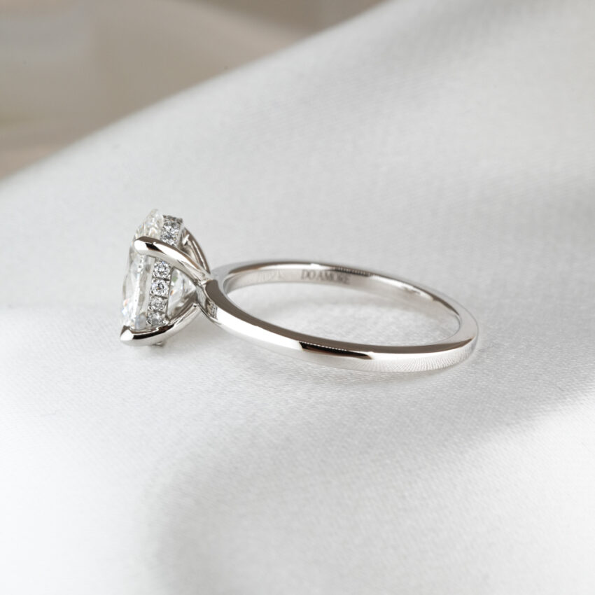 Side view of 2.0 carat ultra low hidden halo engagement ring in_platinum_lifestyle_side
